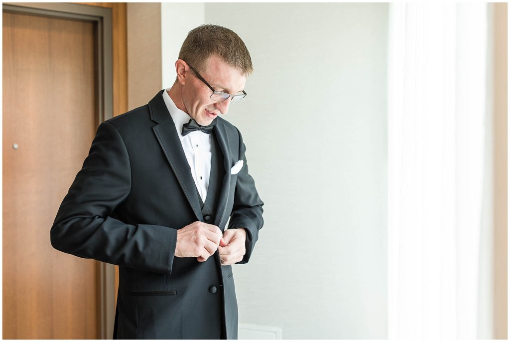 Groom Getting Ready in Black Tuxedo | Marriott Riverfront Wedding in South Sioux City, Nebraska shot by Jessica Brees Photo & Video
